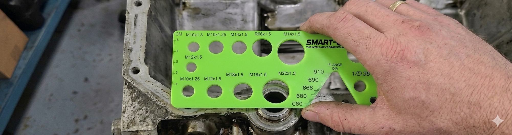 SMART-O® gauge tool being used to check an oil pan drain opening